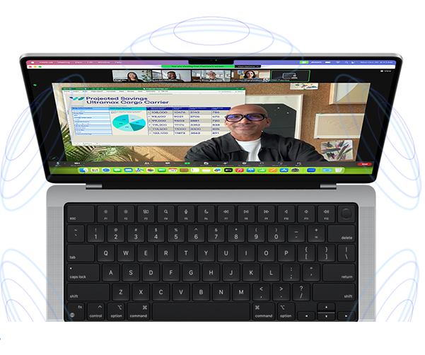 MacBook Pro surrounded by illustrations of blue circles to suggest the 3D feeling of Spatial Audio — Onscreen, a person uses the Presenter Overlay feature in a Zoom video meeting to appear in front of the content they are presenting
